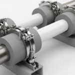 Dual insulated piping system with specialized pipe support shoes in an industrial facility.