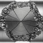Close-up of a fractured steel shaft showing metal fatigue beach marks and failure zones.