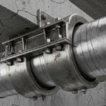 Heavy-duty steel pipe saddle supporting an insulated industrial pipeline