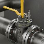 A 3D render of an industrial plug valve installed on a pipeline.