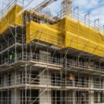 Modern steel modular scaffolding system installed on a multi-story building facade under construction.