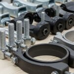 A collection of different types of metal pipe clamps used in plumbing and industrial piping systems.