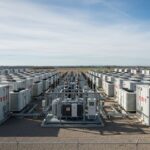 Industrial containerized Battery Energy Storage Systems site showing battery enclosures and power conversion skids.