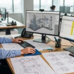 Senior piping engineer analyzing technical drawings and cost data for a Class 2 cost estimate project.