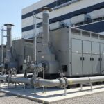 Industrial backup generators for data centres installed in a secure, sound-attenuated outdoor enclosure with visible exhaust and fuel infrastructure.