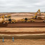 Heavy machinery performing precise site grading and earthwork for a large-scale data centre construction project.