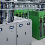 Professional view of high-voltage switchgear and modular UPS systems inside a modern data centre electrical room.