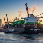 Modern container ship utilizing green ammonia as marine fuel in a global port.