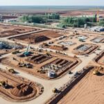 Aerial view of industrial earthworks for green hydrogen plants showing site grading and drainage infrastructure.