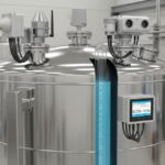 Industrial storage tank with ultrasonic and radar level measurement sensors installed on top.