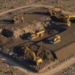 3D engineering visualization of industrial site grading showing cut and fill earthwork operations on uneven terrain.