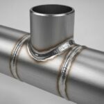 3D render of a steel Weldolet fitting welded to a main run pipe.
