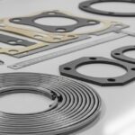 A collection of different industrial pipe flange gaskets on a workbench
